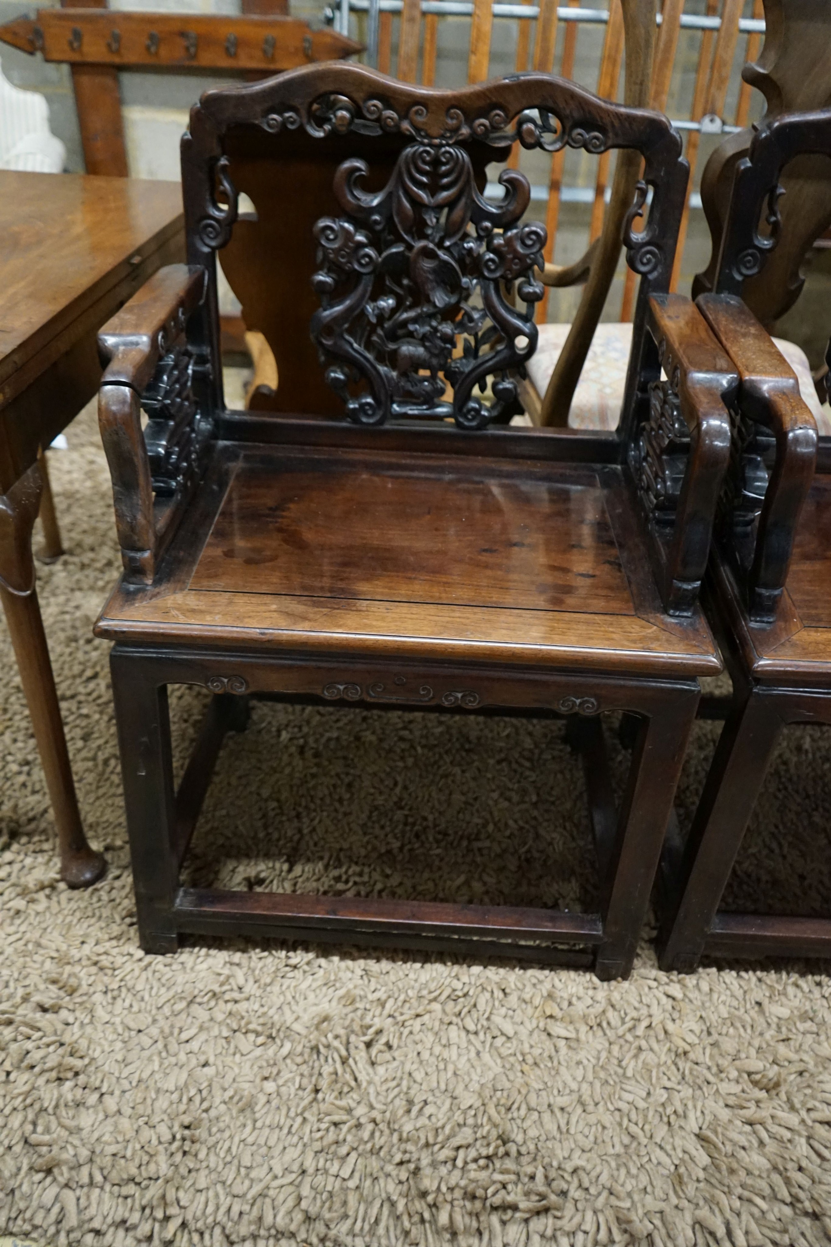 A pair of Chinese carved hongmu elbow chairs (a.f.), width 65cm, depth 48cm, height 96cm